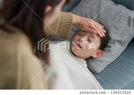 A sick girl and her mother caring for her A sick girl and her mother caring for her 136933926