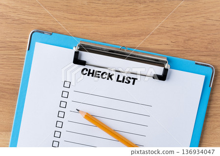 Checklist paper and pencil in a binder Checklist paper and pencil in a binder 136934047