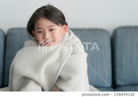 girl wrapped in a blanket girl wrapped in a blanket 136934192