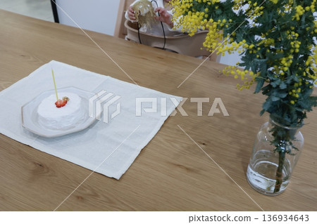 A one-year-old child holding a crown and a smash cake. A one-year-old child holding a crown and a smash cake. 136934643