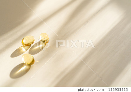 Dietary supplement capsules, vitamins beige background, soft sunlight. Concept for healthy eating, eco-friendly lifestyle, modern wellness branding 136935313