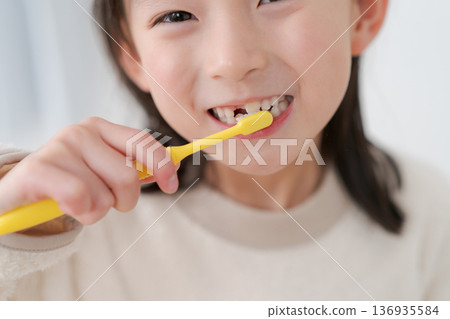 Girls brushing teeth 136935584