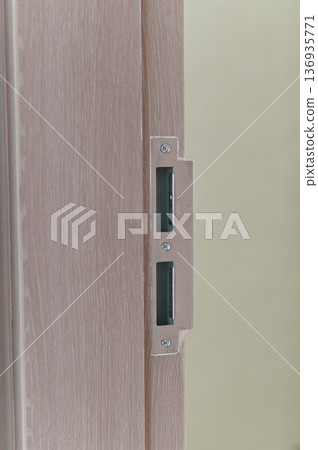 Door wood lock metal security latch closeup interior safety modern vertical brown detail hardware protection residential home construction equipment mechanism safe privacy entry handle install Door wood lock metal security latch closeup interior safety modern vertical brown detail hardware protection residential home construction equipment mechanism safe privacy entry handle install 136935771