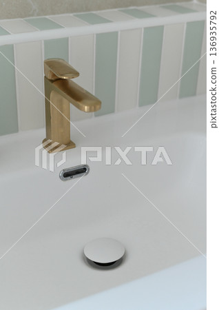 Modern gold faucet white ceramic sink minimalist bathroom clean rectangular basin tiled backsplash contemporary style elegant interior design 136935792