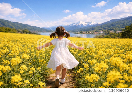 A child running through a rapeseed flower field A child running through a rapeseed flower field 136936020