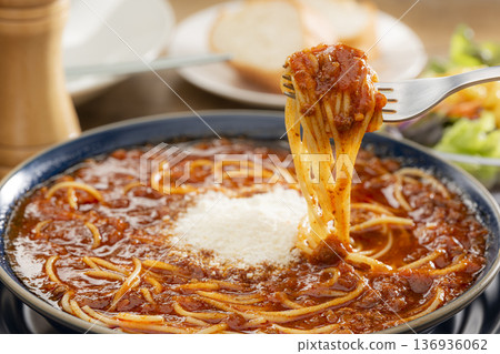 Pick up meat sauce soup pasta topped with grated cheese with a fork Pick up meat sauce soup pasta topped with grated cheese with a fork 136936062