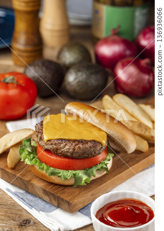 Juicy hamburger with tomato and lettuce Juicy hamburger with tomato and lettuce 136936066