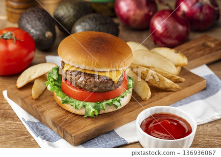Cheeseburger and fries on a wooden board Cheeseburger and fries on a wooden board 136936067
