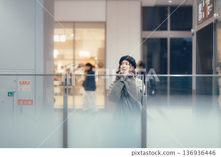 A woman waiting in a train station A woman waiting in a train station 136936446