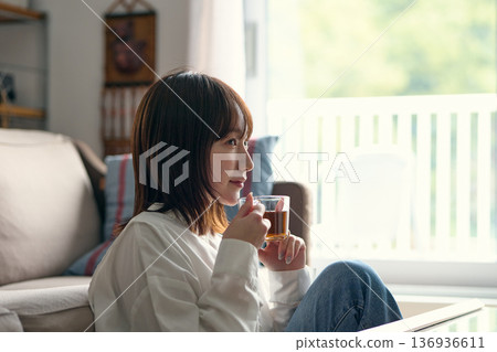 A woman relaxing in the living room 136936611