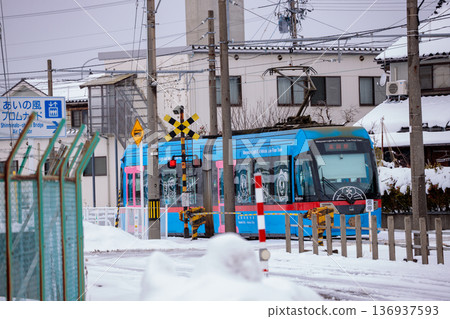 Manyo Line light rail running through a snowy landscape Manyo Line light rail running through a snowy landscape 136937593