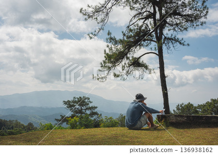 sunrise with man see moving of cloud and clear sky and layer of mountain sunrise with man see moving of cloud and clear sky and layer of mountain 136938162