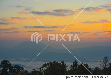 sunrise with moving of cloud and clear sky and layer of mountain sunrise with moving of cloud and clear sky and layer of mountain 136938174