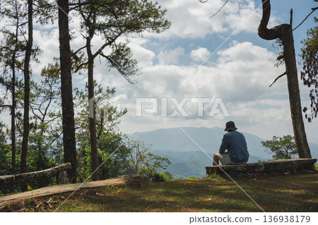 sunrise with man see moving of cloud and clear sky and layer of mountain sunrise with man see moving of cloud and clear sky and layer of mountain 136938179