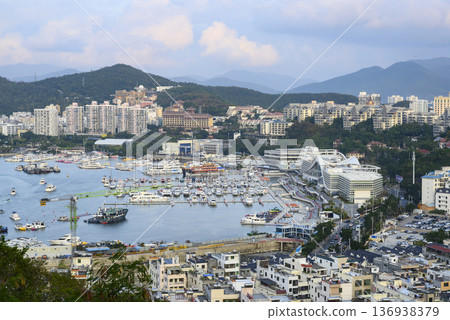 Aerial view of the Sanya city, Hainan, China, the marina with yachts and the mountains Aerial view of the Sanya city, Hainan, China, the marina with yachts and the mountains 136938379