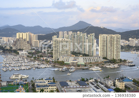 Aerial view of the Sanya city, Hainan, China, the marina with yachts and the mountains Aerial view of the Sanya city, Hainan, China, the marina with yachts and the mountains 136938380