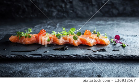 Elegant salmon sushi rolls with microgreens on black slate 136938567
