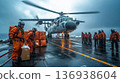 Military helicopter landing on aircraft carrier in stormy weather 136938604