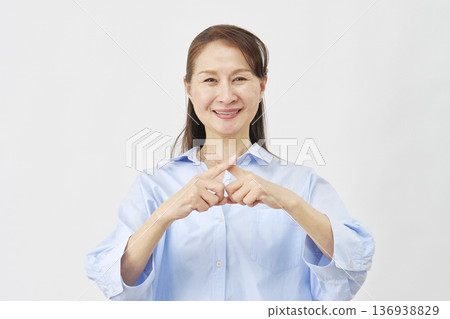 A woman making a "X" sign on a white background A woman making a "X" sign on a white background 136938829