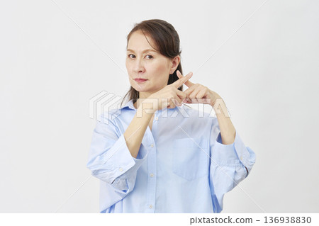 A woman making a "X" sign on a white background A woman making a "X" sign on a white background 136938830