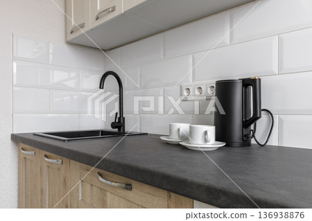 Modern Kitchen Countertop with Black Sink and Electric Kettle Modern Kitchen Countertop with Black Sink and Electric Kettle 136938876