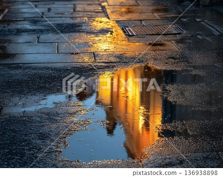 City lights reflected in puddles after the rain. A fantastic cityscape at dusk. 136938898