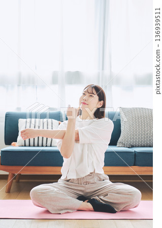 Healthy habits of a woman in her 30s stretching at home 136939511