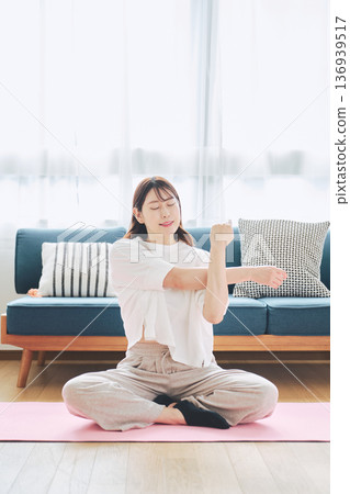 Healthy habits of a woman in her 30s stretching at home 136939517