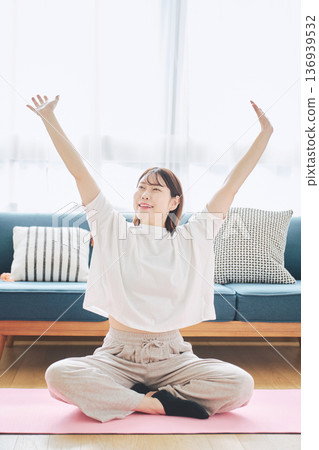 Healthy habits of a woman in her 30s stretching at home 136939532