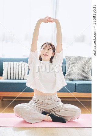 Healthy habits of a woman in her 30s stretching at home 136939533