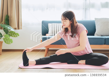 Healthy habits of a woman in her 30s stretching at home 136939534