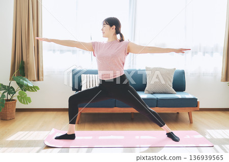 Fitness life of a woman in her 30s doing yoga poses in her living room Fitness life of a woman in her 30s doing yoga poses in her living room 136939565