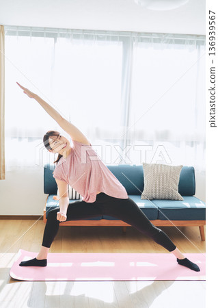 Fitness life of a woman in her 30s doing yoga poses in her living room Fitness life of a woman in her 30s doing yoga poses in her living room 136939567