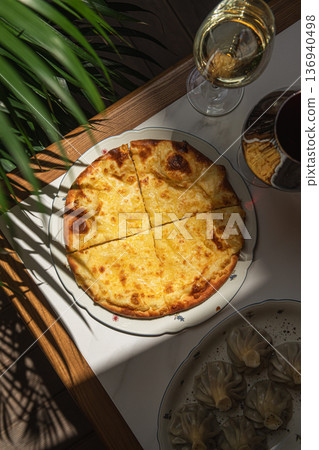 Traditional Georgian khachapuri with melted cheese Traditional Georgian khachapuri with melted cheese 136940498