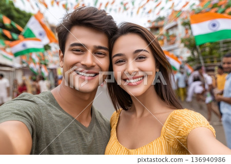 Happy indian couple taking selfie celebrating independence day with flags 136940986