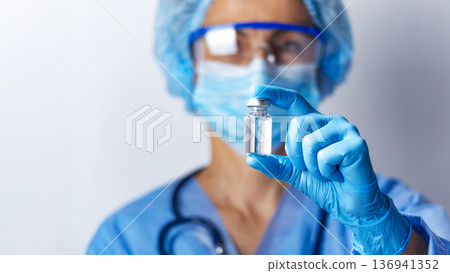 Healthcare Professional Holding a Vaccine Vial 136941352