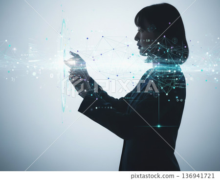 Image of a woman's silhouette operating the latest technology and network 136941721