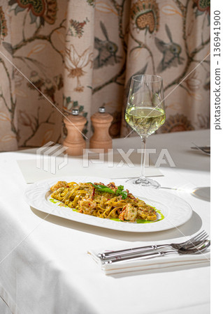 Pasta with shrimp in creamy pesto sauce Pasta with shrimp in creamy pesto sauce 136941900