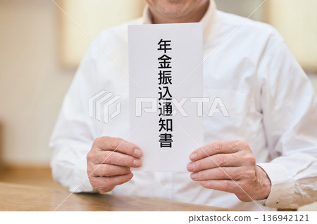 Smiling senior Asian man holding a pension transfer notice Smiling senior Asian man holding a pension transfer notice 136942121