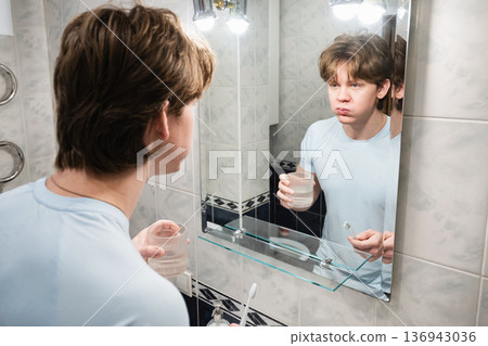 Rinsing mouth with glass of water. Brushing Teeth Rinsing mouth with glass of water. Brushing Teeth 136943036