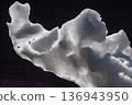 A mass of melted snow that has taken on a sculptural shape 136943950