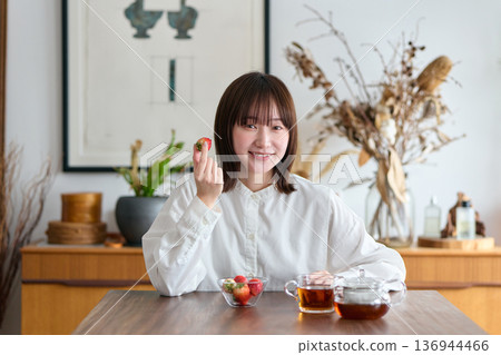 Woman eating strawberries 136944466