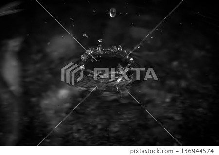 water droplets falling on the water surface 136944574