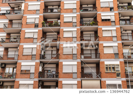 Residential apartment building facade with balconies and windows in Rome, Italy 136944762