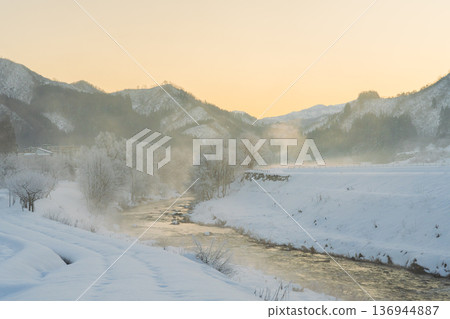 River and frost on a winter morning with river mist rising River and frost on a winter morning with river mist rising 136944887