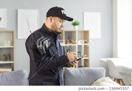 Detective Or Police Officer Filling Out Report At Crime Scene Investigation Detective Or Police Officer Filling Out Report At Crime Scene Investigation 136945507