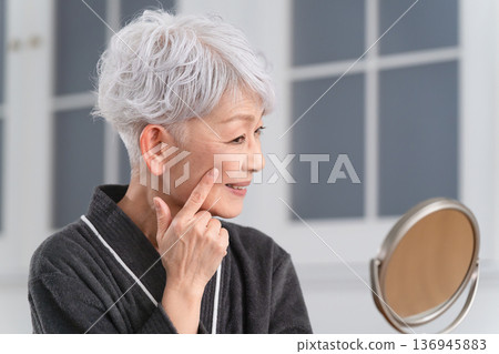 Senior woman doing skin care beauty image 136945883