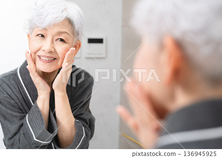 Senior woman doing skin care beauty image Senior woman doing skin care beauty image 136945925