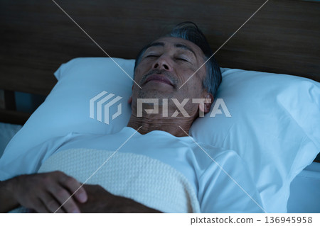Senior man sleeping in bed Lifestyle image Senior man sleeping in bed Lifestyle image 136945958