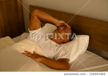 Senior man sleeping in bed Lifestyle image 136945968